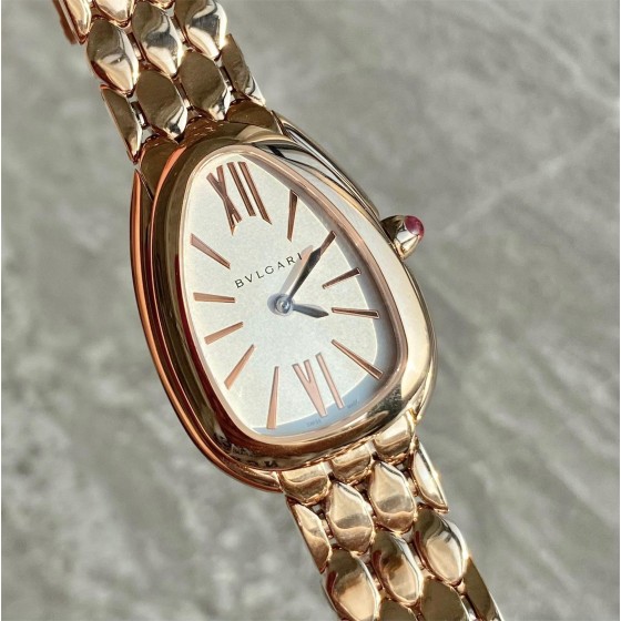 Bulgari snake watch with white dial and gold strap