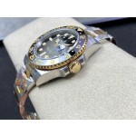 Rolex GMT-Master series, black dial, black bezel, 40mm, silver and gold Oyster bracelet.