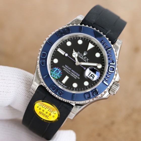 Rolex Yacht-Master series, black dial, blue bezel, silver case, 40mm, rubber strap.
