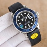 Rolex Yacht-Master series, black dial, blue bezel, silver case, 40mm, rubber strap.