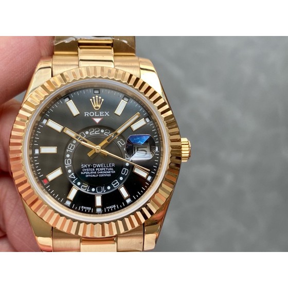 Navigator series men's watch with bright black dial, gold bezel, 42mm case, and gold Oyster bracelet.