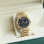Sunday calendar series men's watch, black dial, gold bezel, 40mm, gold President-style bracelet.