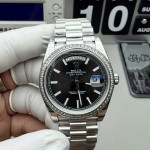Sunday calendar series men's watch, black dial, diamond-set bezel, 40mm, silver President-style bracelet.
