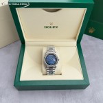 Sunday Calendar series women's watch with diamond-set gradient blue dial, diamond-set bezel, 36mm case, and silver President-style bracelet.
