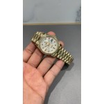 Sunday calendar series women's watch, silver dial, diamond-set bezel, 36mm, gold President-style bracelet.