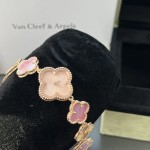 Van Cleef & Arpels watch with a rose gold dial featuring a pink mother-of-pearl clover motif.