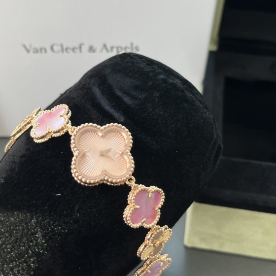 Van Cleef & Arpels watch with a rose gold dial featuring a pink mother-of-pearl clover motif.