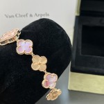 Van Cleef & Arpels watch with a rose gold dial featuring a pink mother-of-pearl clover motif.