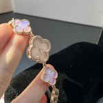 Van Cleef & Arpels watch with a rose gold dial featuring a pink mother-of-pearl clover motif.