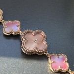Van Cleef & Arpels watch with a rose gold dial featuring a pink mother-of-pearl clover motif.