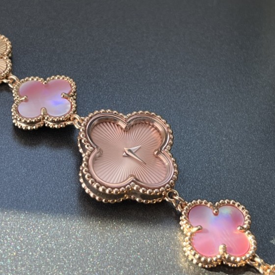 Van Cleef & Arpels watch with a rose gold dial featuring a pink mother-of-pearl clover motif.