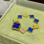 Van Cleef & Arpels watch with blue mother-of-pearl and diamond-set clover motif, featuring a blue dial.