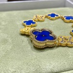 Van Cleef & Arpels watch with blue mother-of-pearl and diamond-set clover motif, featuring a blue dial.