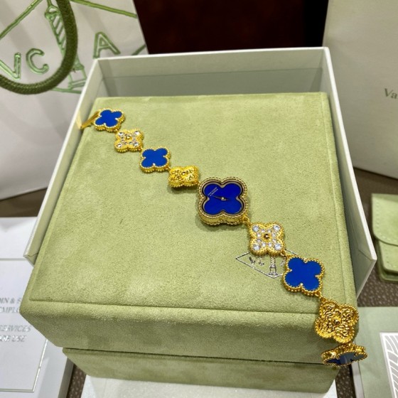 Van Cleef & Arpels watch with blue mother-of-pearl and diamond-set clover motif, featuring a blue dial.