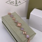 Van Cleef & Arpels watch with a rose gold dial featuring a pink mother-of-pearl clover motif.