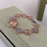 Van Cleef & Arpels watch with a rose gold dial featuring a pink mother-of-pearl clover motif.
