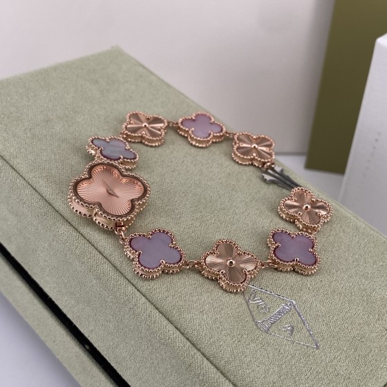 Van Cleef & Arpels watch with a rose gold dial featuring a pink mother-of-pearl clover motif.