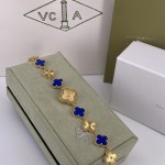 Van Cleef & Arpels Alhambra watch with a gold dial and blue mother-of-pearl clover motif.