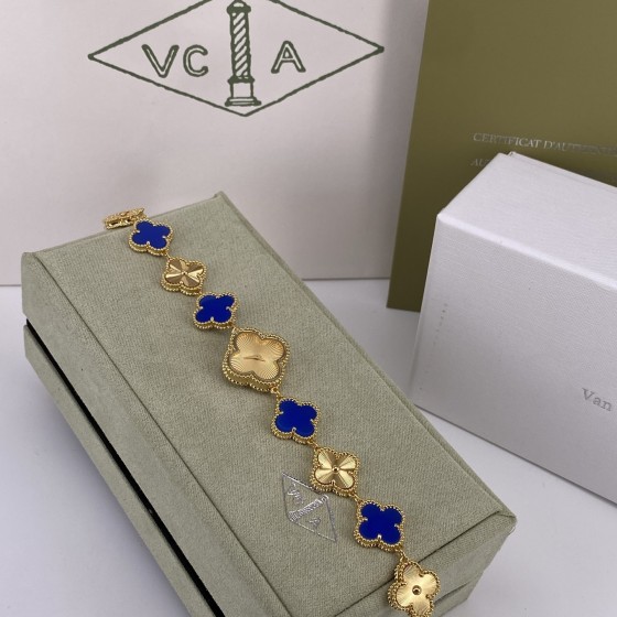 Van Cleef & Arpels Alhambra watch with a gold dial and blue mother-of-pearl clover motif.