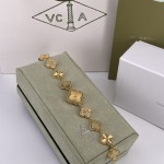 Van Cleef & Arpels watch with gold dial, mother-of-pearl, and diamond-set clover motif.
