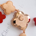 Van Cleef & Arpels watch with a brown dial and red mother-of-pearl clover motif.