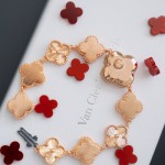 Van Cleef & Arpels watch with a brown dial and red mother-of-pearl clover motif.