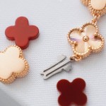 Van Cleef & Arpels watch with a brown dial and red mother-of-pearl clover motif.