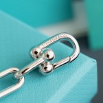 Tiffany watch with silver chain, diamond accents, and white dial
