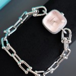 Tiffany watch with silver chain, diamond accents, and white dial