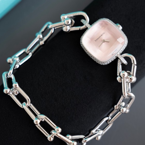 Tiffany watch with silver chain, diamond accents, and white dial