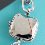 Tiffany watch with silver chain, diamond accents, and white dial