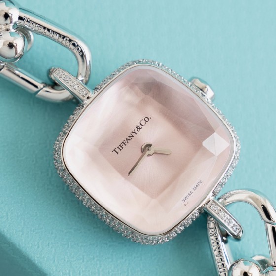 Tiffany watch with silver chain, diamond accents, and white dial