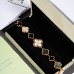Van Cleef & Arpels Alhambra watch with white dial and black and white mother-of-pearl clover motifs