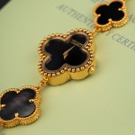 Van Cleef & Arpels Alhambra watch with black and white mother-of-pearl clover motifs and a black dial.