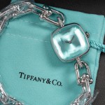 Tiffany watch with silver chain, diamond accents, and blue dial