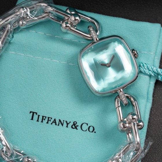 Tiffany watch with silver chain, diamond accents, and blue dial