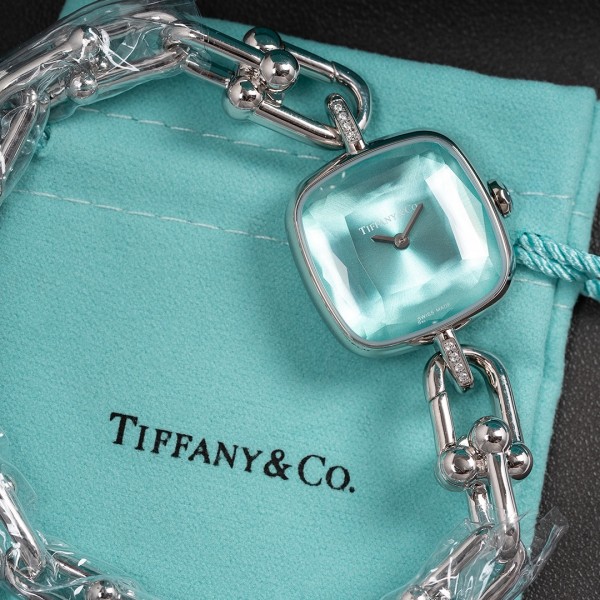 Tiffany watch with silver chain, diamond accents, and blue dial