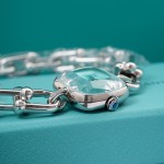 Tiffany watch with silver chain, diamond accents, and blue dial