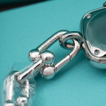 Tiffany watch with silver chain, diamond accents, and blue dial