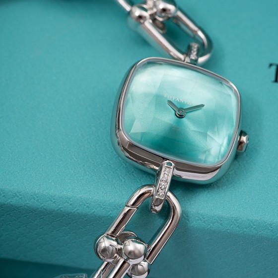 Tiffany watch with silver chain, diamond accents, and blue dial