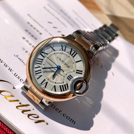 Cartier Ballon Bleu series, 33mm ladies' watch with silver dial and rose gold bezel, two-tone rose gold strap, mechanical movement.