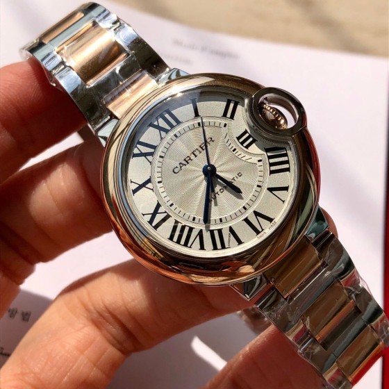 Cartier Ballon Bleu series, 33mm ladies' watch with silver dial and rose gold bezel, two-tone rose gold strap, mechanical movement.