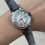 Cartier Ballon Bleu 36mm mechanical women's watch with silver dial, diamond-set bezel, and black leather strap.