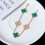 Four-leaf clover and peacock green enamel bracelet with interspersed rhinestones.