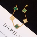 Four-leaf clover and peacock green enamel bracelet with interspersed rhinestones.