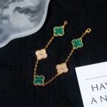 Four-leaf clover and peacock green enamel bracelet with interspersed rhinestones.