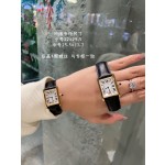 Cartier Tank watch, gold bezel, black leather strap.